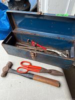toolbox open showing contents and loose tools