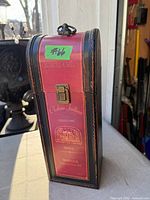 Front view of wooden wine bottle gift box with latch and handle