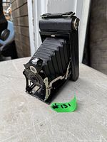 Camera partially opened showing bellows and lens assembly