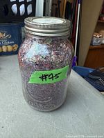 Front view of glass jar showing contents and lid