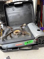 Iwatani stove opened in case showing burner, controls and interior