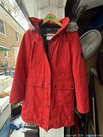 Front view of red Calvin Klein hooded parka hanging