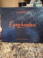 Front of LANGMANNI Eyeshadow Stick Set showing branding and weight