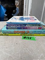 Stack of five children’s books showing spines and titles