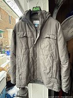Front view of grey Columbia hooded winter jacket hanging