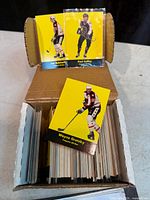 Open cardboard box showing numerous cards, top card Wayne Gretzky