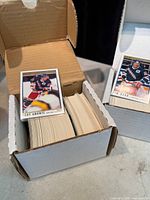 Open box showing stack of hockey cards with Tony Amonte card on top