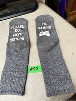 Both socks laid flat showing full length and sole text