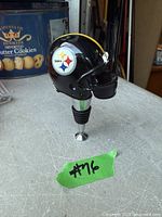 Side view showing Steelers logo on helmet wine stopper