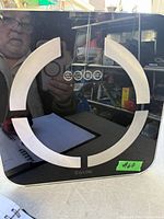 Front view of Taylor black glass digital scale showing sensor pads and display