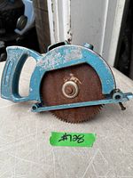 Front view of blue metal circular saw attachment showing handle, blade and mounting bolt