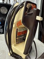 Side view of GE Light'n Easy iron showing handle, cord, control dial and settings label