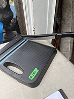 Overall view of black X-Acto guillotine paper cutter showing grid, ruler and blade arm