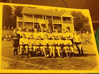 Full view of mounted sepia team photograph with clubhouse background and Japan flag
