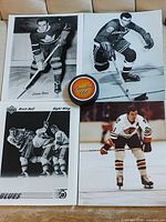 Group shot of all four photos and Canadian Club puck