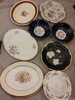 All eight serving pieces arranged together showing fronts and lid