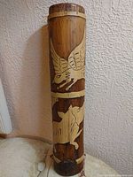 Full view of cylindrical carved bamboo container