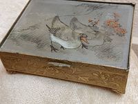 Closed box showing painted glass lid with ducks and metal exterior designs