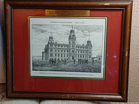 Overall view of framed print with red mat and wooden frame