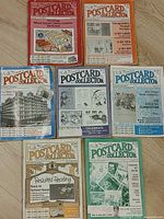 Seven vintage Postcard Collector magazines from 1991-1992 laid out to show each cover