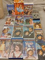 Overall view showing 14 Shirley Temple VHS movies arranged in rows