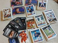 Assorted sports and Star Trek trading cards spread on floor
