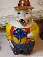 Front view of the McCoy Winking Pig cookie jar with lid in place