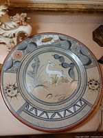 Full view of signed Tonala pottery plate showing deer, cactus, floral and sunface motifs