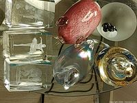 Group view showing all paperweights and glass candle