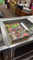 Stack of vintage Conan and Kull comic books on display case