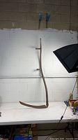 Full view of scythe upright on table