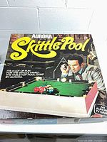 Box lid showing Aurora Skittle Pool graphics and branding