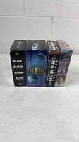 Front view of four DVD box sets standing side by side