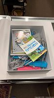 Open box showing Wii game manuals and accessories