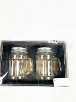 Front view of boxed pair of glass shakers