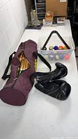 Pool balls in tote with triangle rack, croquet bag and gloves overview