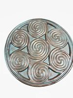 Front of round resin plaque showing spiral design