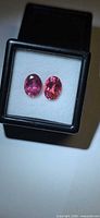 Pair of oval pink tourmalines in display box, top view