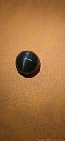 Cabochon gemstone showing cat’s eye effect