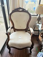 Front view of carved balloon back armchair