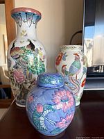 All three porcelain vases displayed together