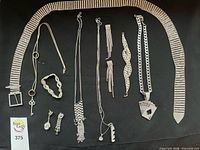 Entire lot laid out to show all pieces including belt, necklaces, bracelets and earrings