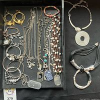 Tray overview showing full assortment of jewelry and two statement necklaces