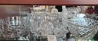 Shelf with multiple crystal bowls, dish and glasses