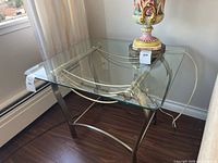 Full view of glass and metal side table by window