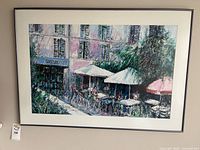 Full view of framed artwork showing café scene