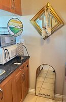 Overall lot showing stained glass panel, both mirrors, desk lamp and shell tassels