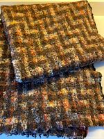 Folded felted wool fabric showing overall pattern and thickness.