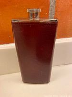 Front view of burgundy leather-wrapped flask