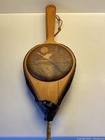 Front view showing inlaid wood scene and entire bellows